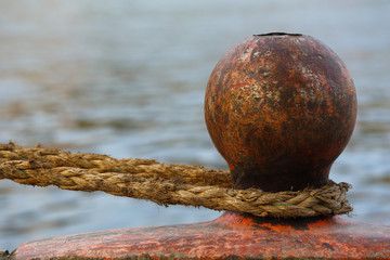 Bollard with a rope on a deck.