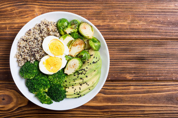 Buddha bowl with quinoa , eggs , avocado , brussels sprouts and broccoli