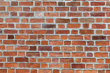 Natural old vintage weathered red brown solid brick wall. Abstract copy space background.
