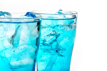 blue drink with ice cubes on white background