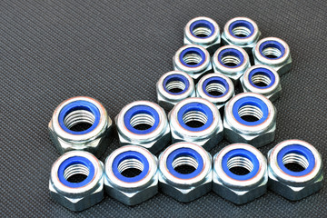 Nylon lock nuts on dark background. Copy space.