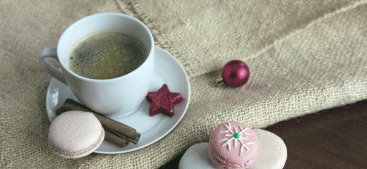 Colorful macaroons and coffee cup. Christmas card.