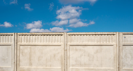 Concrete fence against the blue sky.