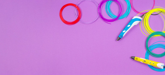 3d pens with colourful plastic filament on purple background