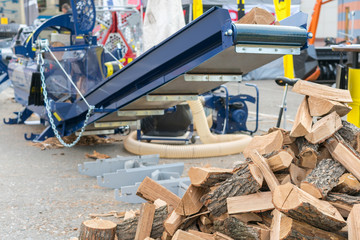 Machine for cutting firewood. chopping firewood with a machine close up