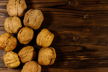 Walnuts on wooden table. Top view, copy space