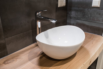 White top ceramic washbasin with glossy metal mixer