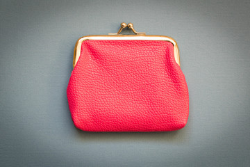 Pink wallet blue background . The concept of savings. Top view