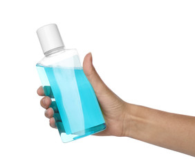 Woman holding bottle with mouthwash for teeth care on white background