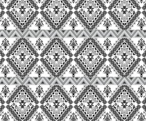 Vector geometric seamless pattern. Traditional folk ornament. Texture with small rhombuses, flower silhouettes, diamond shapes. Tribal ethnic motif. Red, black and white colors. Repeat background