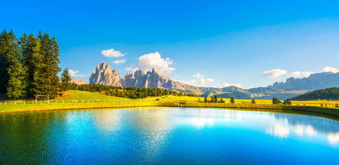 Fototapeta na wymiar Lake and mountains, Alpe di Siusi or Seiser Alm, Dolomites Alps, Italy.