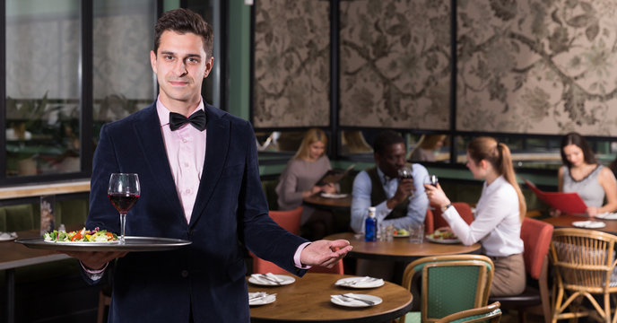 Elegant waiter with serving tray