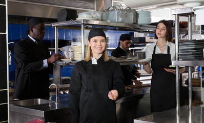 Confident woman chef in restaurant kitchen