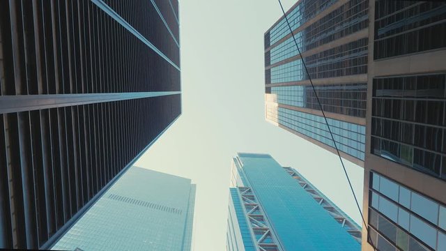 TRACKING GIMBAL Walking camera straight up through modern skyscraper buildings in downtown New York, USA. 4K UHD