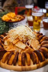 Delicious snacks for beer, near a glass beer