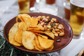 Delicious snacks for beer. Crispy chips with nuts