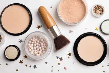 Flat lay composition with makeup products and Christmas decor on white background