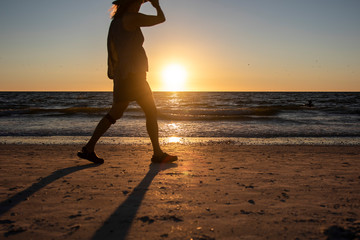 people walking silhouette sunset beach