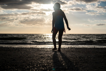kid walking silhouette sunset beach