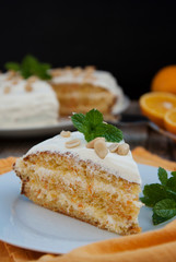 Orange and carrot cake, wooden background. Rustic style.