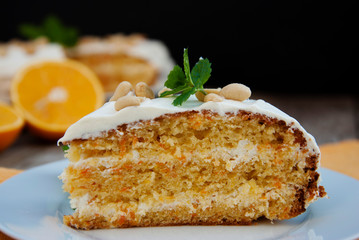 Orange and carrot cake, wooden background. Rustic style.