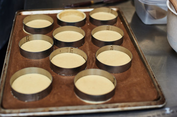 Process of making tart with salted caramel french dessert. Food industry, mass or volume production.