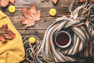 Autumn fashion seasonal concept sweater cardigan Scandinavian knitted scarf cup hot black tea