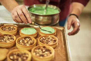 Process of making tart with salted caramel french dessert. Food industry, mass or volume production.