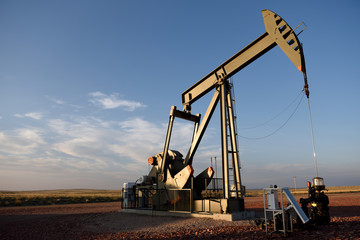 Close up view of a crude oil pump jack, rural fields and blue sky, Powder River Basin, Wyoming