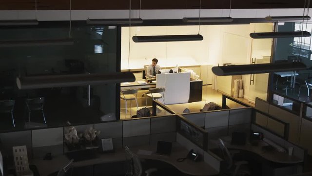 Young manager working alone in an empty office, elevated view