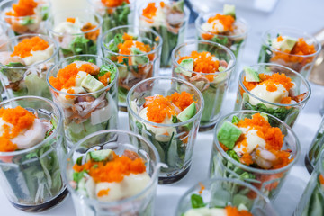 Party catering Cocktail food on a mini dish and tiny glass bowls.