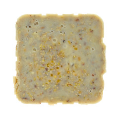 Top view of a cake of beef rendered suet wild bird food isolated on a white background.