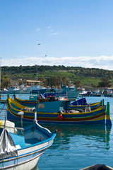 Fototapeta na wymiar Boats in Marsaxlokk harbour