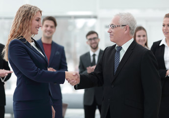 handshake serious businessman and business woman