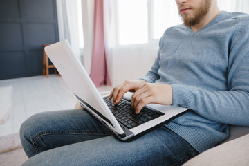 Man working with a laptop at home, close up. Freelance, technology, online studying and e-banking