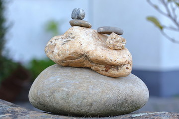 Stone figure against blurred background, frog of pebble stones, humor, meditation, calm, reflect,...