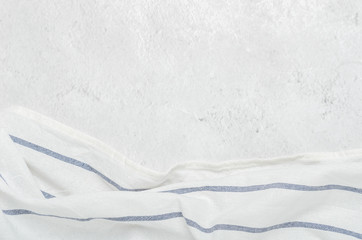 White clean towel on a light gray stone background. Minimalist kitchen