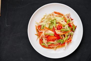 Thai spicy food "Som tum" or green papaya salad.