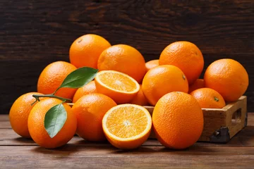 Zelfklevend Fotobehang fresh orange fruits in a box on wooden table © Nitr