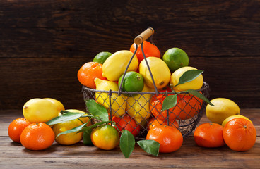 fresh fruits in a basket on wooden table