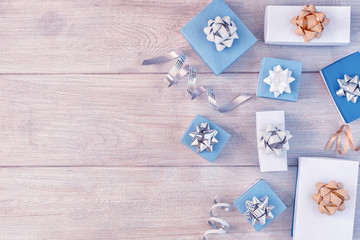 White and blue gift boxes with beautiful bows, decorative ribbons. Christmas composition with place for text, copy space.