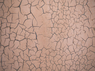 The texture of old orange paint with cracks.