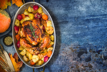 Served roasted Thanksgiving Turkey with vegetables on blue stone background