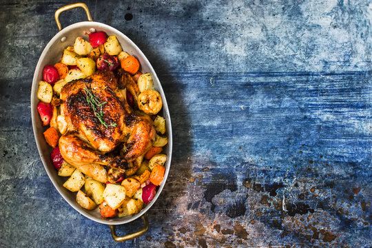 Served roasted Thanksgiving Turkey with vegetables on blue stone background
