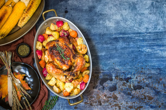 Served roasted Thanksgiving Turkey with vegetables on blue stone background