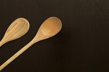 Wooden spoons on black table