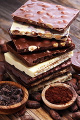 Chocolate bars on table with chocolate tower.