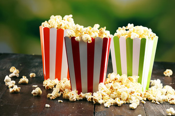 Cinema concept with popcorn in green white bag.