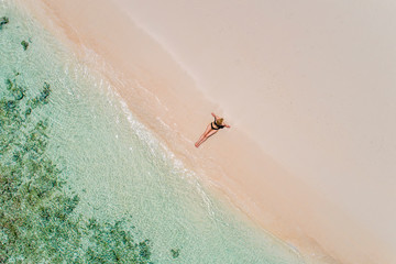 Fototapeta na wymiar Aerial drone aerial view of Beautiful girl having fun on the sunny tropical beach. Seychelles