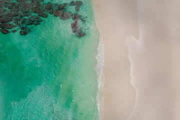 Beautiful tropical white empty beach and sea waves seen from above. Seychelles beach aerial view